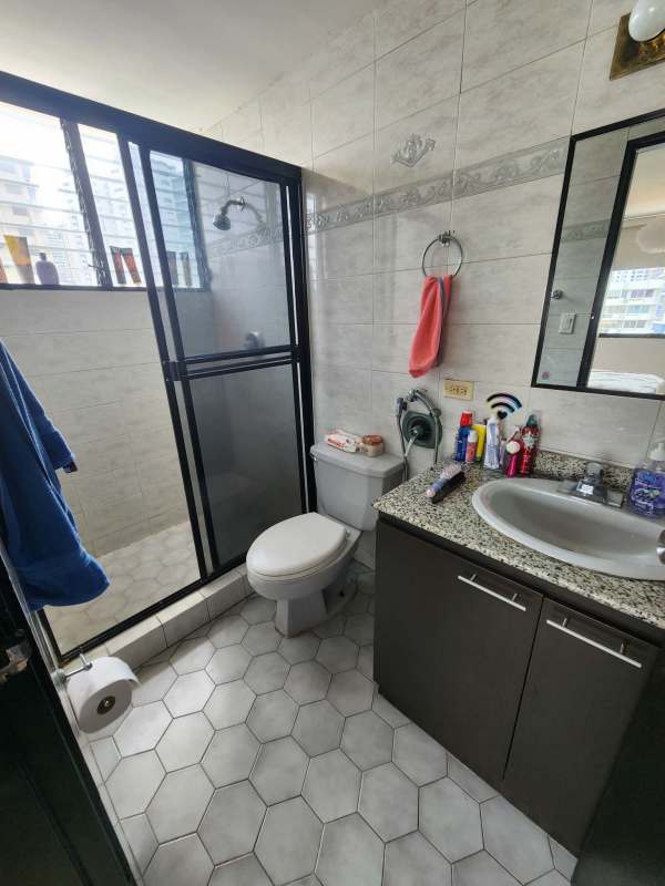 Contemporary bathroom with glass-enclosed shower and granite surface in Torre Marbella Panama