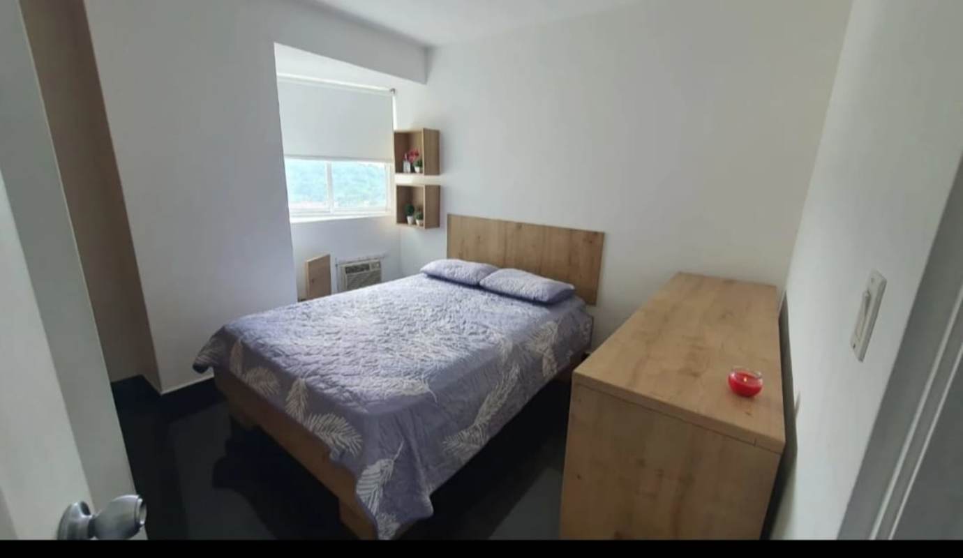Modern small bathroom with glass shower enclosure and wood cabinet in PH Majestic Garden Panama