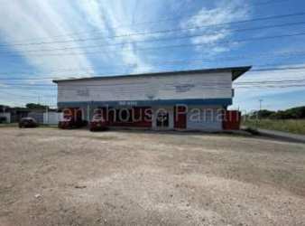 Large white commercial warehouse building with parking lot in Aguadulce Panama