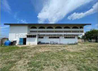White two-story building with arched balconies in commercial lot Aguadulce Panama
