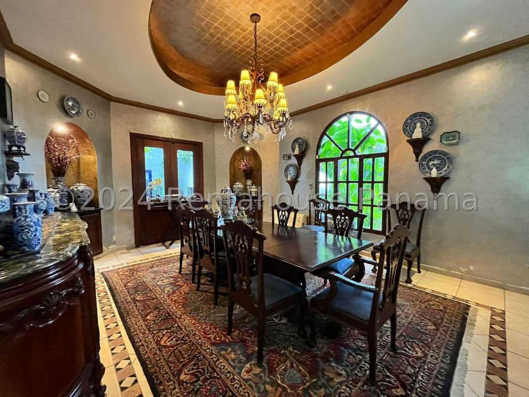 Elegant traditional dining room with chandelier arched window classic decor Coco del Mar Panama luxury villa