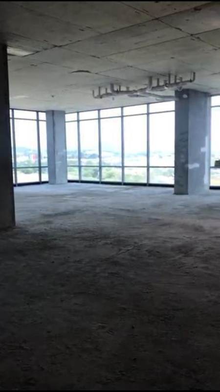 Interior of shell commercial space with floor-to-ceiling windows overlooking Santa Maria Panama