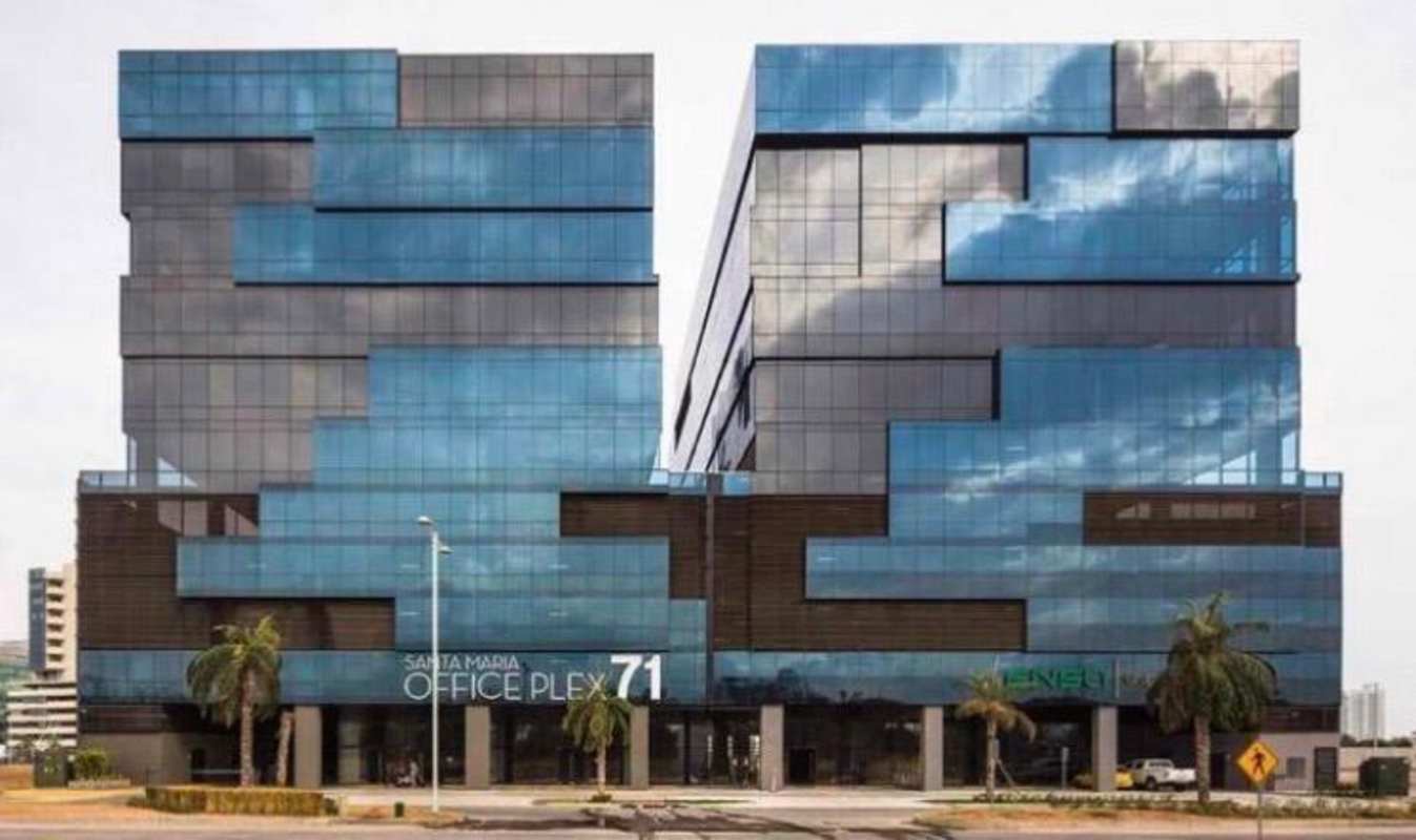 Two glass towers of Santa Maria Office Plex in Panama with palm trees and signage