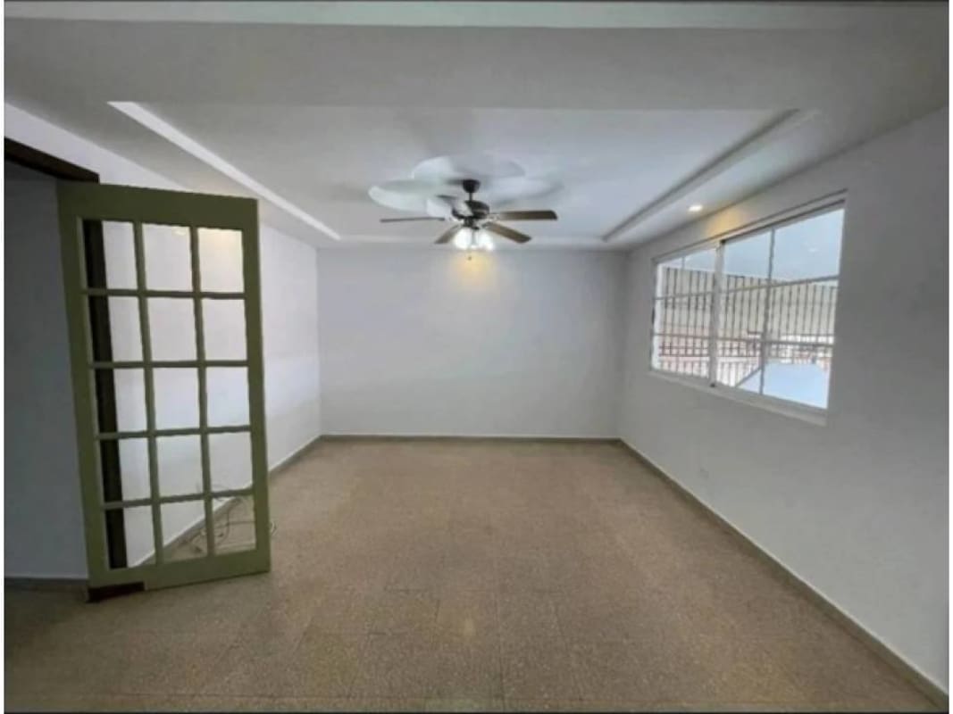 Covered parking space with stone wall accents and security bars in Cerro Viento Panama