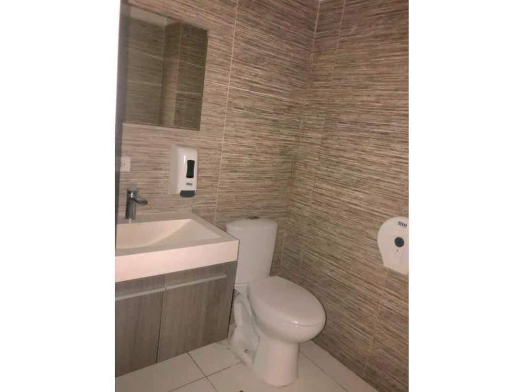 Minimalist bathroom with tiled walls, mirror and fixtures PH Obarrio Plaza Panama City