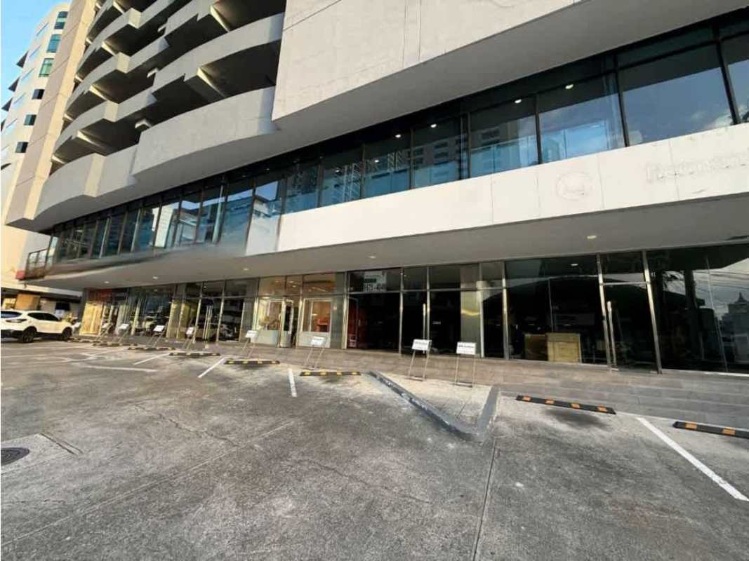 Glass storefronts and adjacent parking spaces at PH Obarrio Plaza Panama's commercial facade
