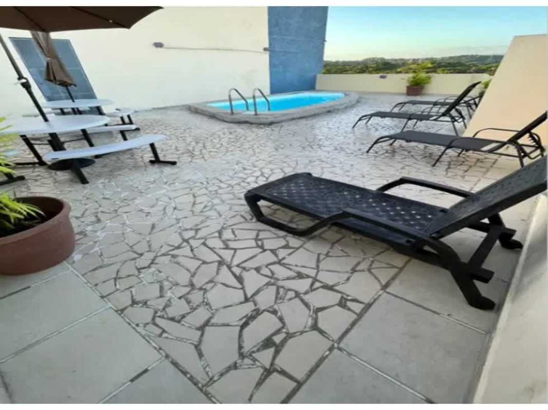 Community rooftop terrace with pool, lounge chairs, cityscape at PH Vista Esmeralda Panama