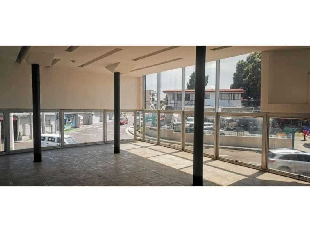 Open-plan commercial interior with floor-to-ceiling windows overlooking Costa del Este street