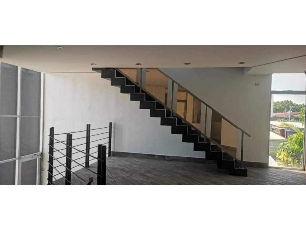 Interior foyer with floating staircase and glass doors in Costa del Este commercial tower Panama