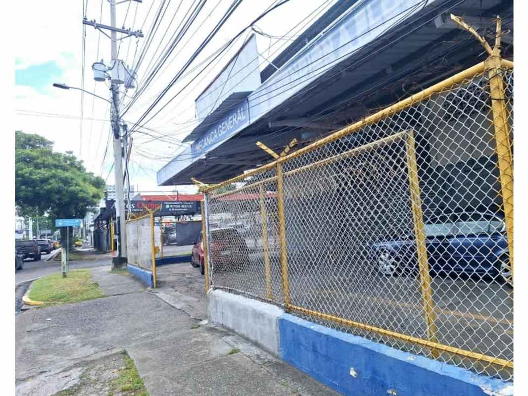 Warehouse entrance with multiple roller shutter doors and parking at Parque Lefevre Panama