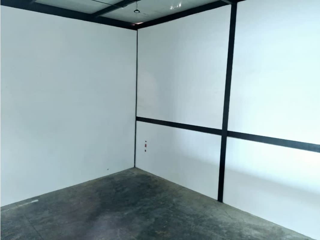 Contemporary commercial warehouse facade red brick glass balcony Las Americas Pacora Panama