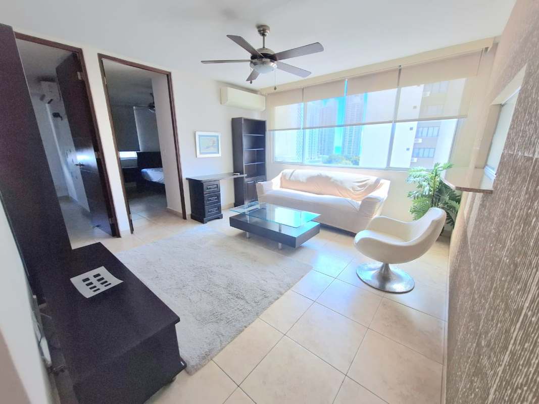 Spacious living area with natural light, balcony access, panoramic city views