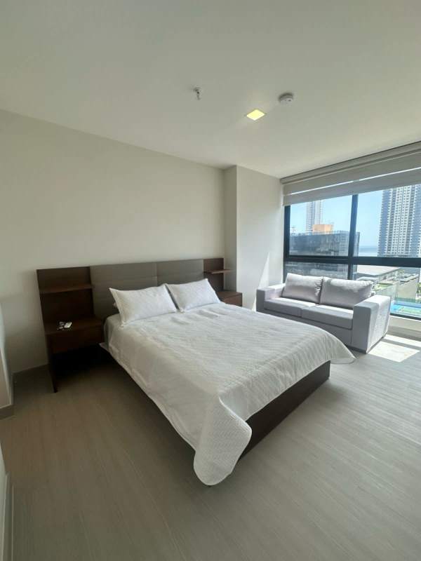 Bedroom with large window city view TV sofa PH Costa del Este Tower Panama