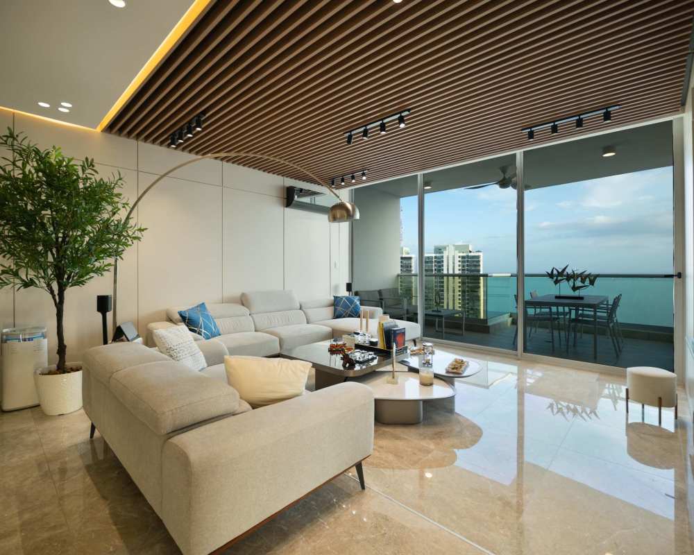 Living room with marble floors, floor-to-ceiling glass doors to balcony and ocean view in PH Costanera