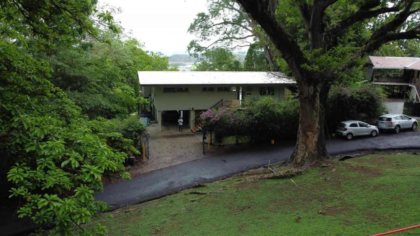Bright kitchen with large window granite countertops and forest views in Cerro Ancón Panama house