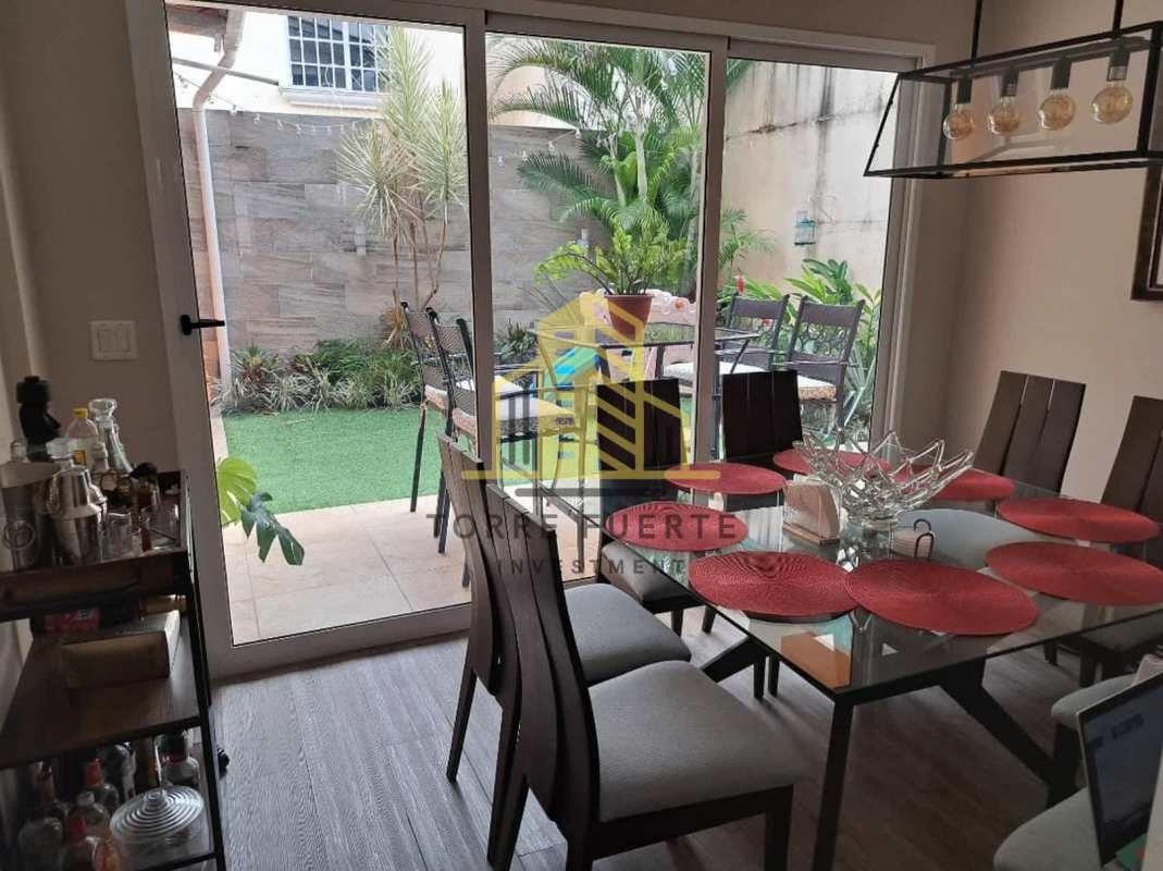 Dining room facing private garden in gated Villa Lucre residential house for sale