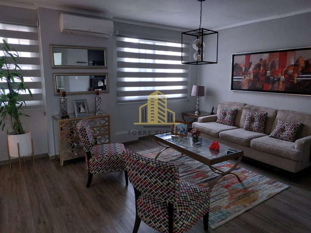 Modern living room with neutral decor and wood flooring Villa Lucre house Panama