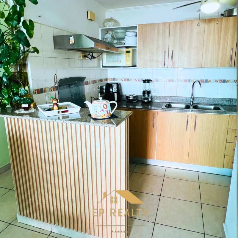 Renovated kitchen with granite countertops, wooden cabinets, breakfast bar at PH Parque Lefevre Tower Panama