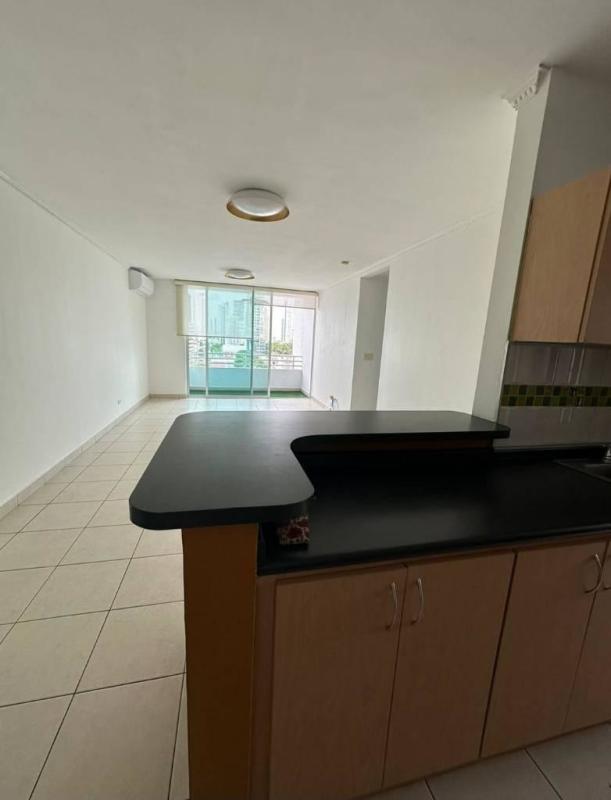 Open-plan kitchen with breakfast bar and living area with balcony access in PH Concept San Francisco Panama