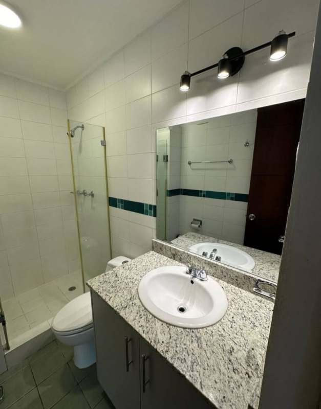 Bathroom with granite countertop, glass shower enclosure, modern fixtures at PH Concept San Francisco Panama
