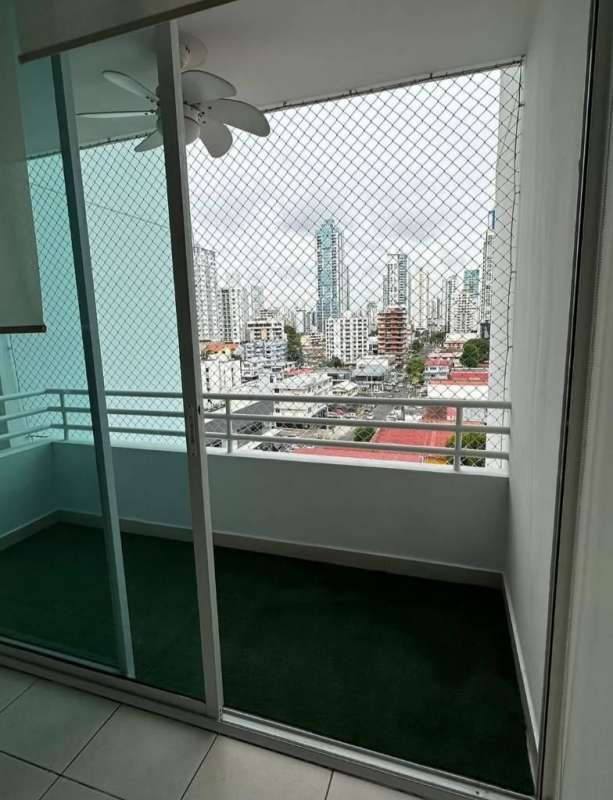 Balcony with artificial grass, safety netting, ceiling fan, skyline view at PH Concept San Francisco Panama