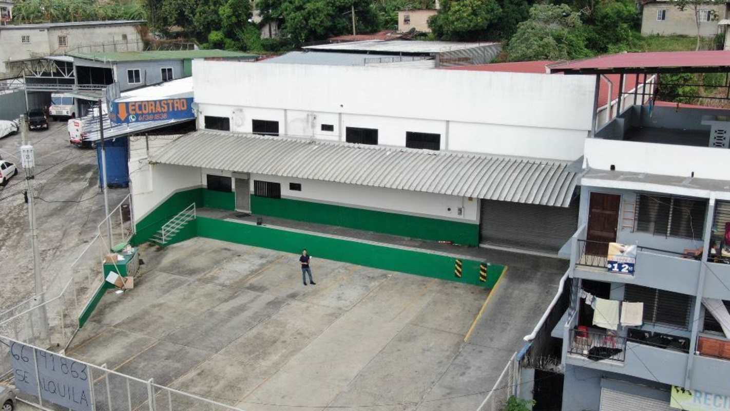 Aerial of warehouse complex with gated parking, loading docks, near major roads in Pueblo Nuevo Panama
