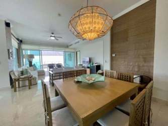 Modern dining and living room with panoramic windows and contemporary furnishings in Bijao Balboa 6