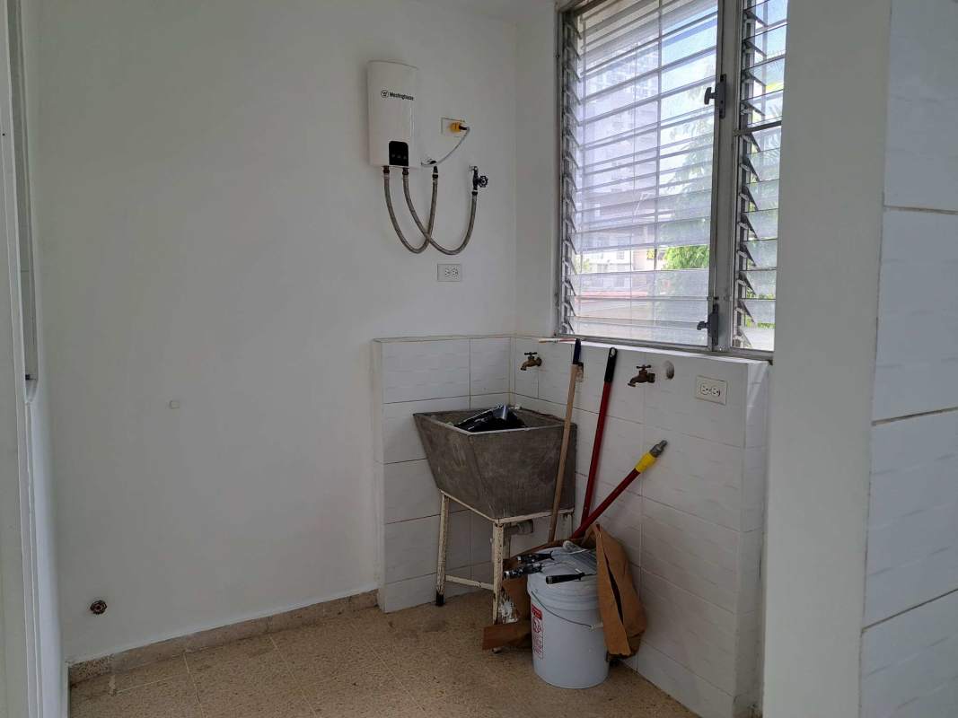 Spacious kitchen with granite countertop, light cabinetry and large window in El Carmen apartment