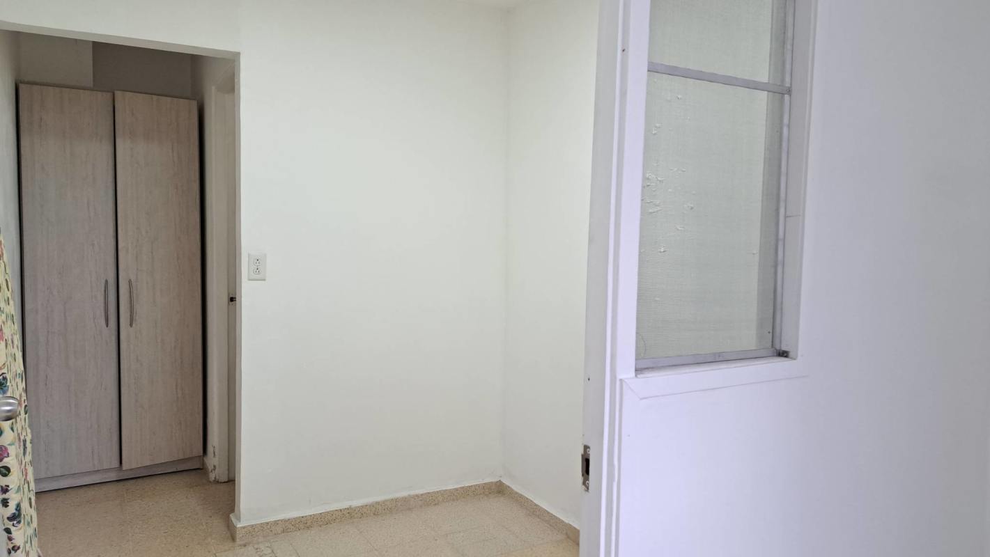 Second bedroom with wardrobe and beige ceramic tile floors in PH El Carmen