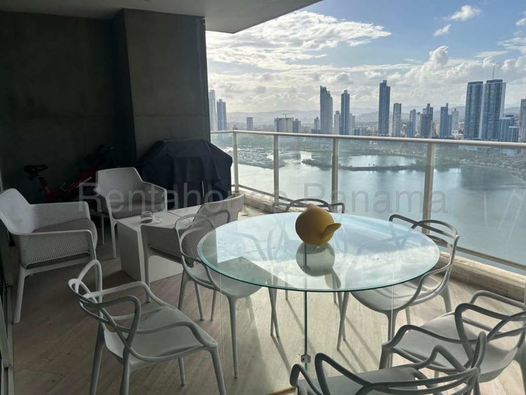 Expansive modern balcony with dining area overlooking Pacific Ocean Panama City