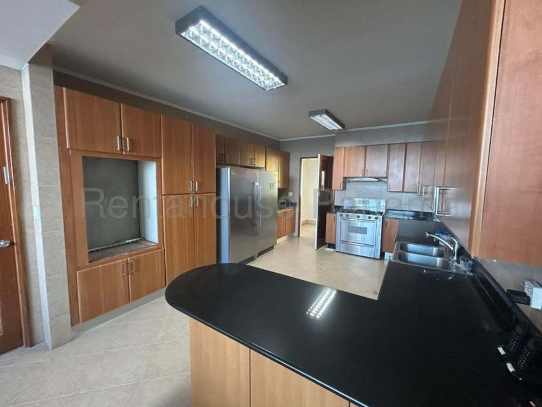 Luxurious kitchen with black granite counters, built-in appliances in Punta Paitilla