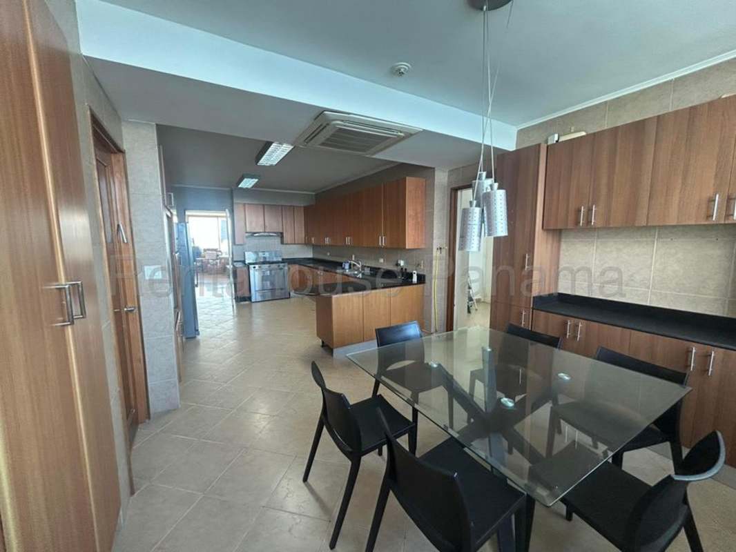 Spacious kitchen with wood cabinetry, granite counters, stainless appliances Punta Paitilla