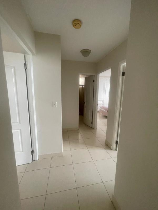 Spacious master bedroom with large window city skyline view PH Oceania Panama