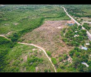 Aerial view of large empty land plot against green backdrop rural Panama Oeste