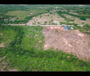 Aerial photo of mostly cleared rural land parcel near billboard on Panamericana Highway