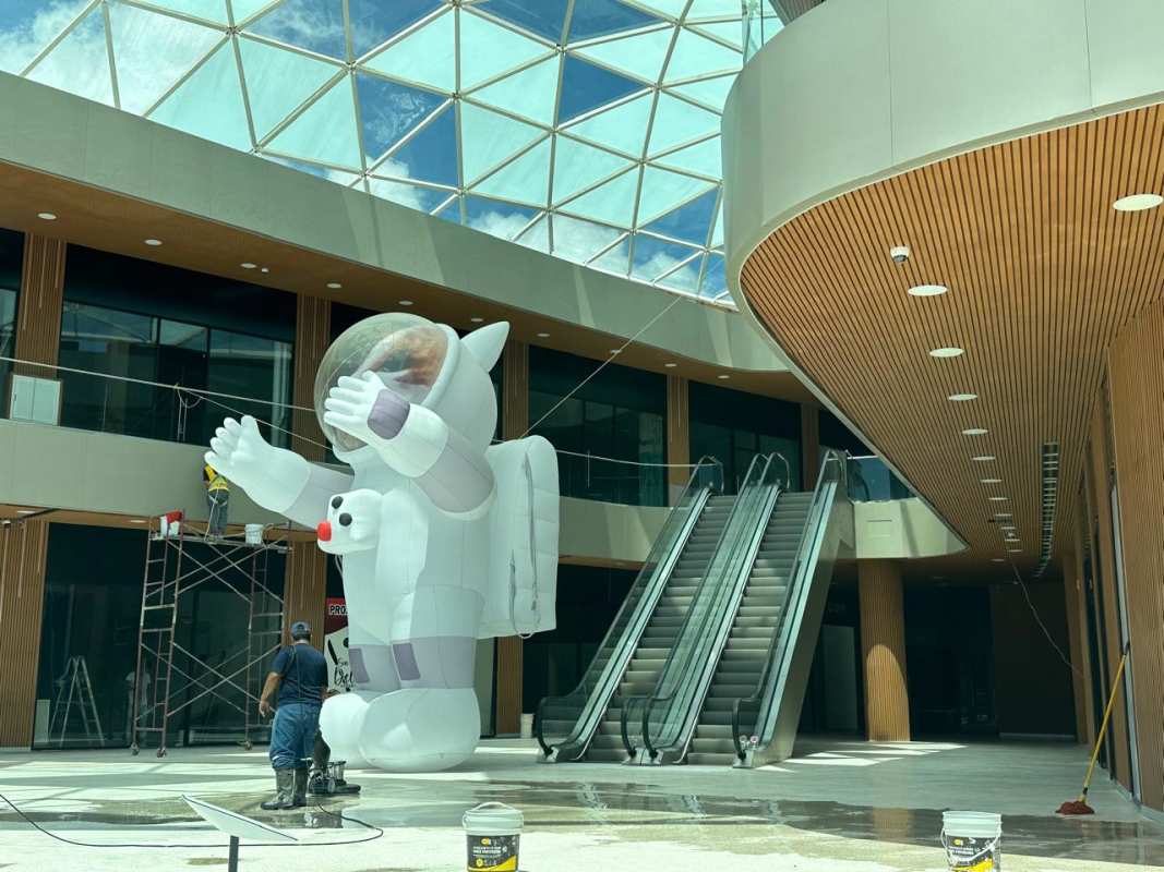 Glass dome atrium with escalators inside modern Panama Plaza on Vía Transístmica, Panama