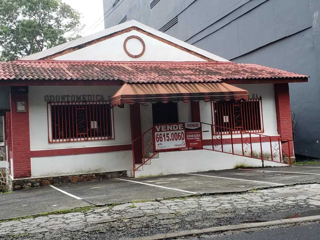 Retail property for sale with red roof, signage space, parking area on Calle 50 Bella Vista Panama City