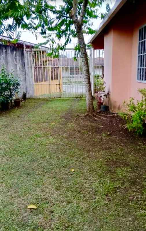 Spacious living and dining room with ceramic tile flooring and large windows at house Brisas del Golf Panama