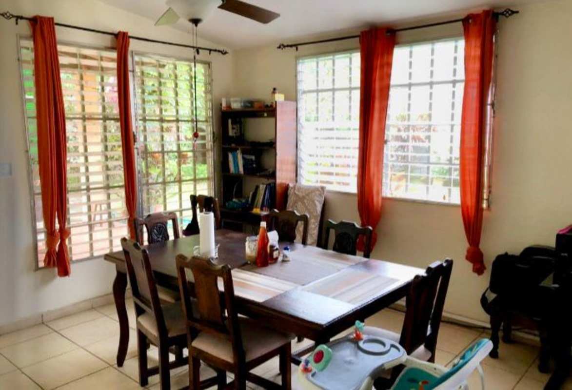 Dining space with ceiling fan, tiled floor, barred windows in house Cerro Viento Panama