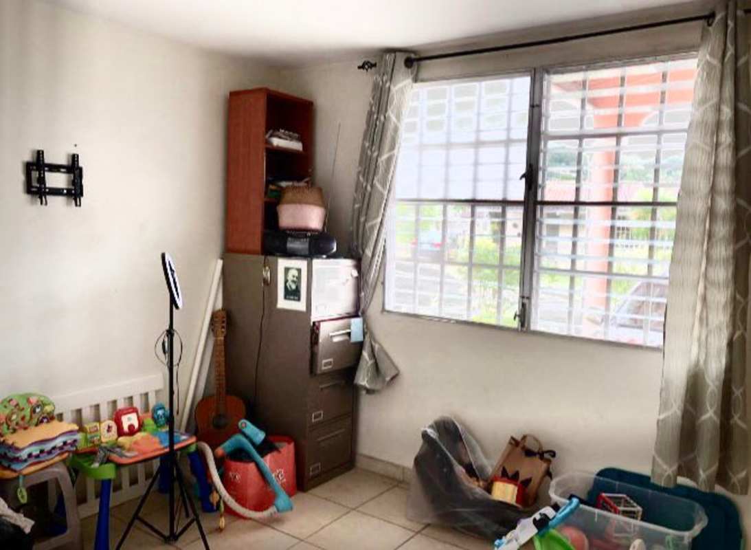 Private backyard with lawn and garden in family home Cerro Viento Panama City