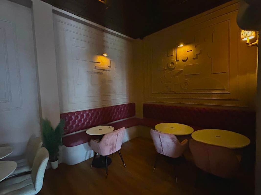 Contemporary cafe space with abstract wall design, velvet chairs, in Casco Viejo commercial building for sale