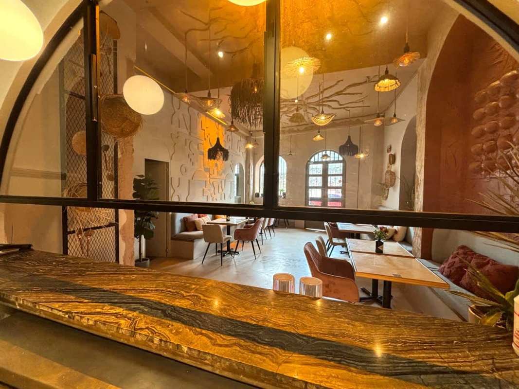 Restaurant dining with natural stone counter, eclectic lighting, arched windows in Casco Antiguo Panama
