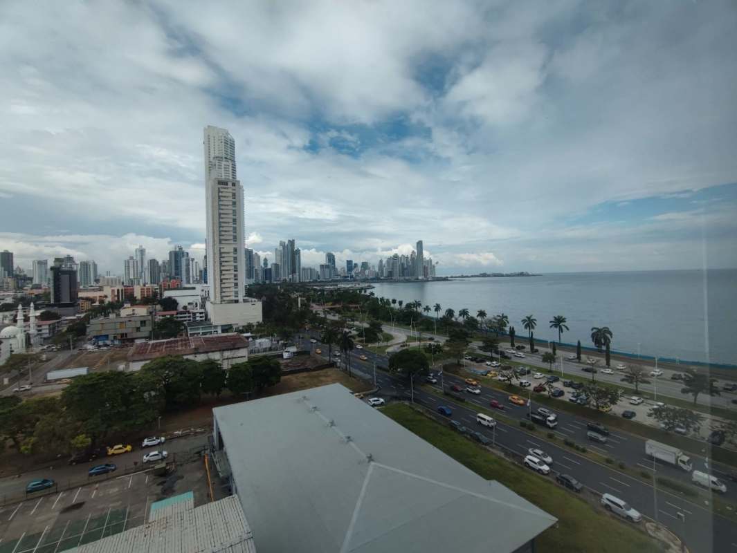 Unfinished open-plan commercial space with panoramic floor-to-ceiling windows overlooking ocean Panama