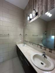 Modern bathroom with glass enclosure, dual sinks and tile at Bijao Beach Resort Panama