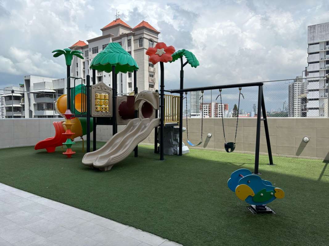 Colorful rooftop playground with city skyline backdrop in Rainbow Tower Panama
