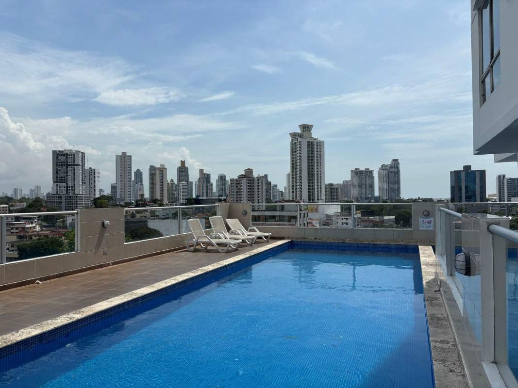 Rooftop pool deck area with city skyline at PH Rainbow Tower El Carmen