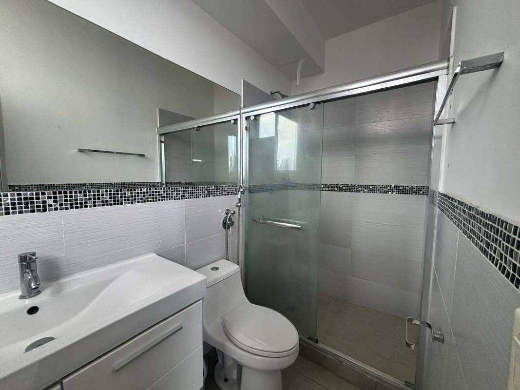 Bright bedroom with large city view window at PH Rainbow Tower Panama City