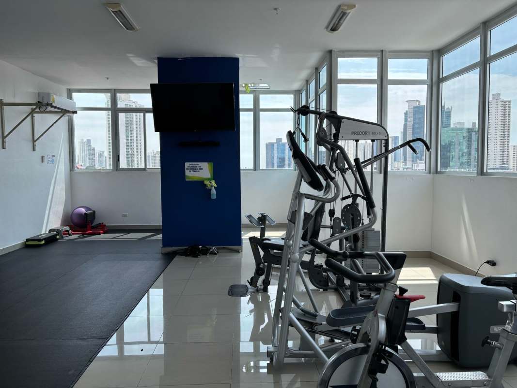Indoor gym with city skyline views at PH Rainbow Tower Panama apartment