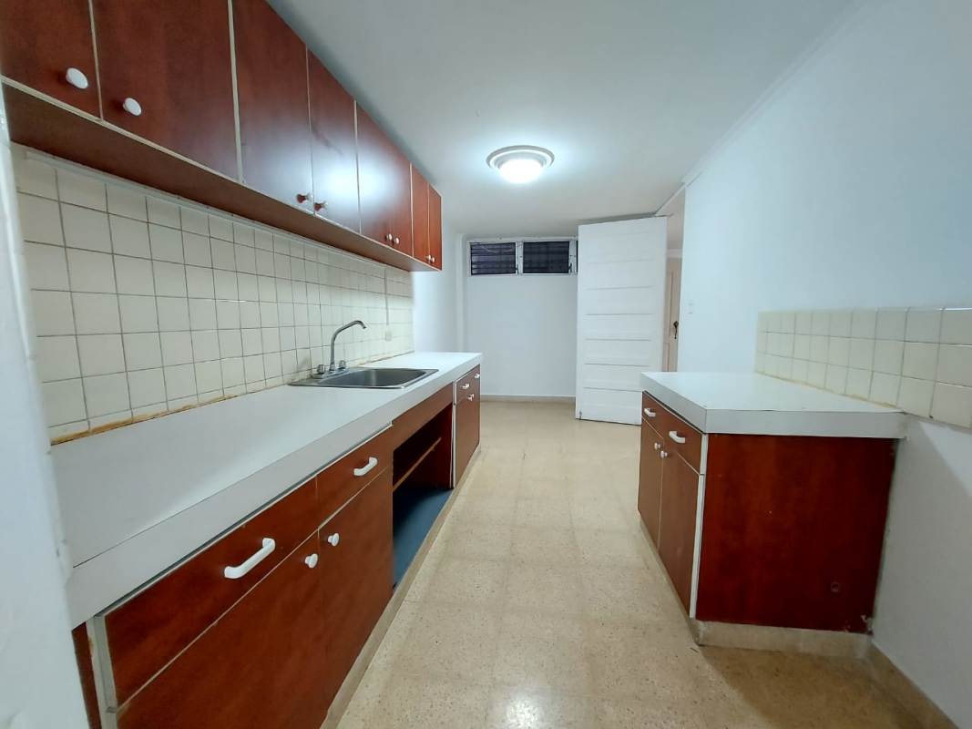 Traditional kitchen with cabinets and tile backsplash El Cangrejo Panama