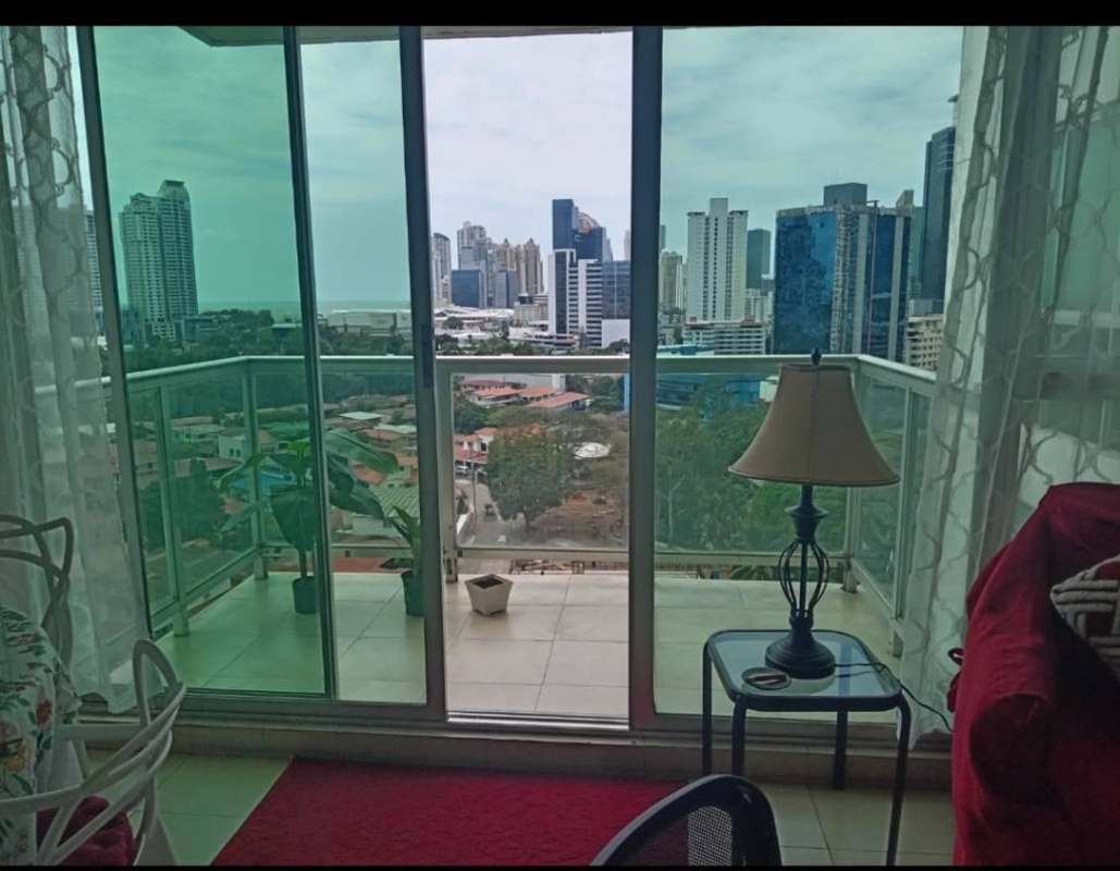 Kitchen with granite counter, stove, and large window in PH Oasis Towers Panama City